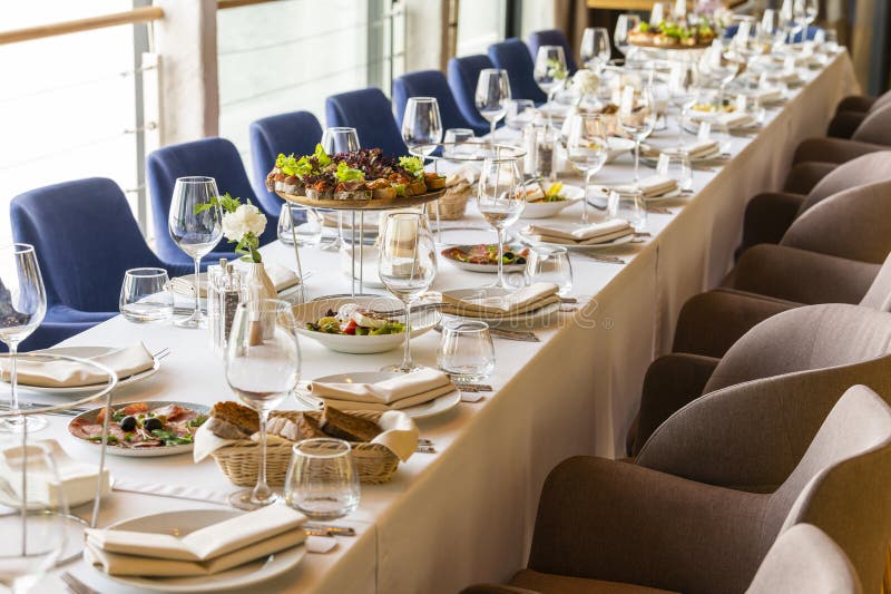 Served table in a restaurant for receiving guests stock images
