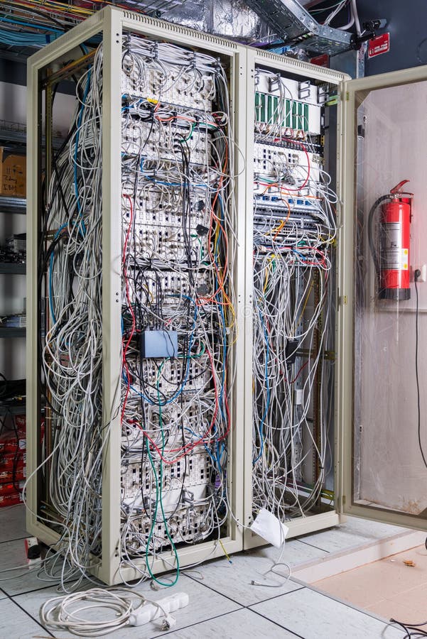 Server room rack with tangled network cables creating messy unti royalty free stock images