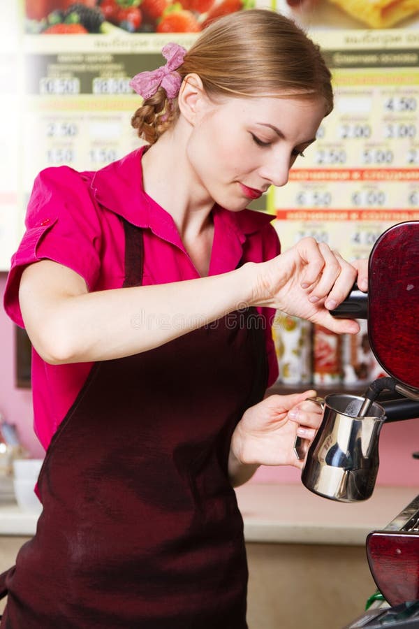 Friendly waitress making coffee at coffee machine. Friendly waitress making coffee at coffee machine