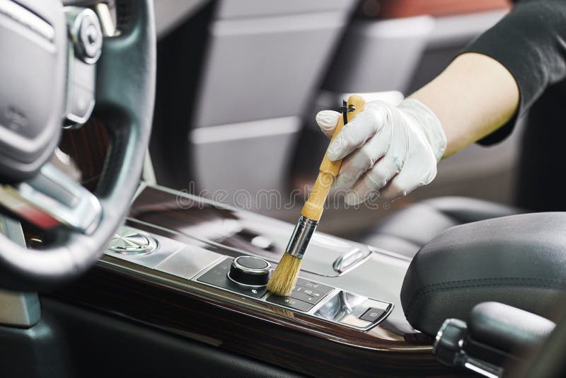 Automobile detailing service. cleaning car interior - steering wheel with brush. Automobile detailing service. cleaning car interior - steering wheel with brush