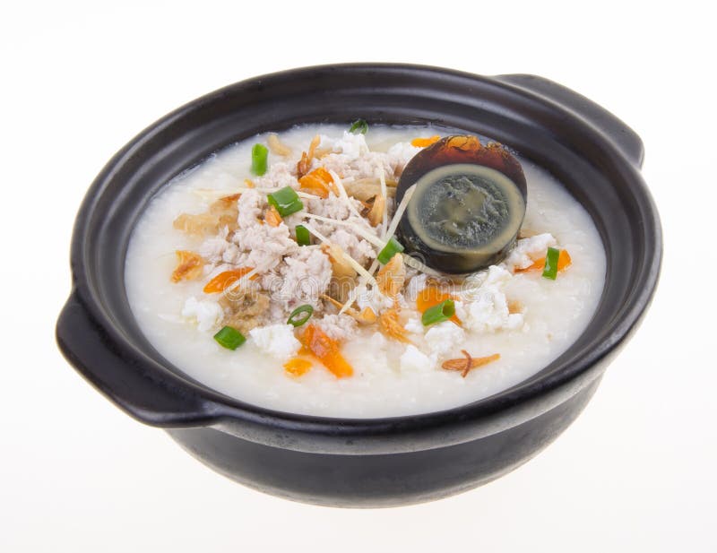 Service de gruau de riz de gruau d'oeufs et de porc de siècle de chinois traditionnel images stock Service de gruau de riz de gruau d'oeufs et de porc de siècle de chinois traditionnel images stock