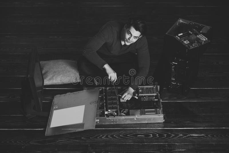 Service maintenance of computers. engineer man fix motherboard with screwdriver royalty free stock images