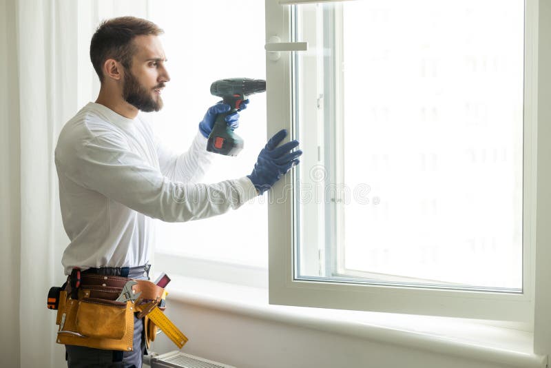 Service Man Installing Window with Screwdriver Stock Photo - Image of ...