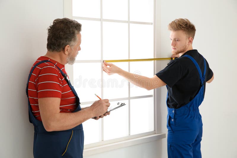 Service Men Measuring Window for Installation Stock Image Image of