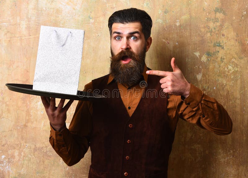 Service and purchase concept. Waiter with white package