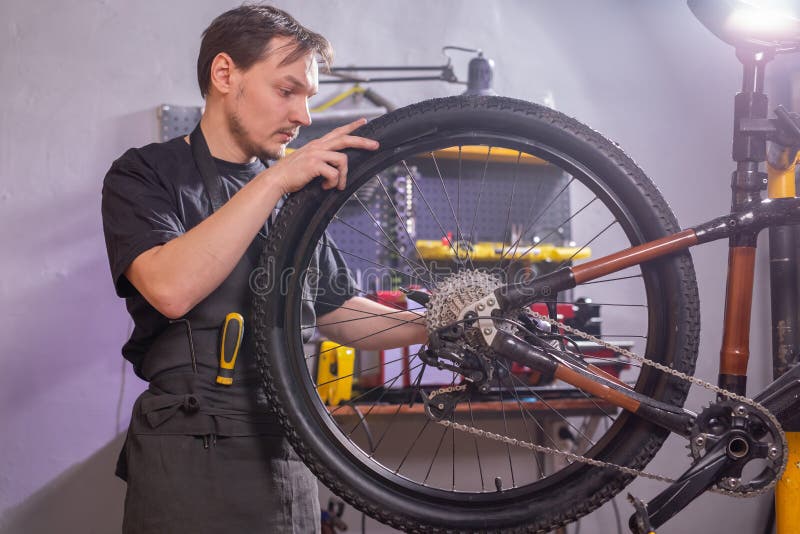 Service, Repair, Bike and People - Mechanic Repairing a Mountain Bike in a Workshop Stock - Image of craft, fixing: 203470651