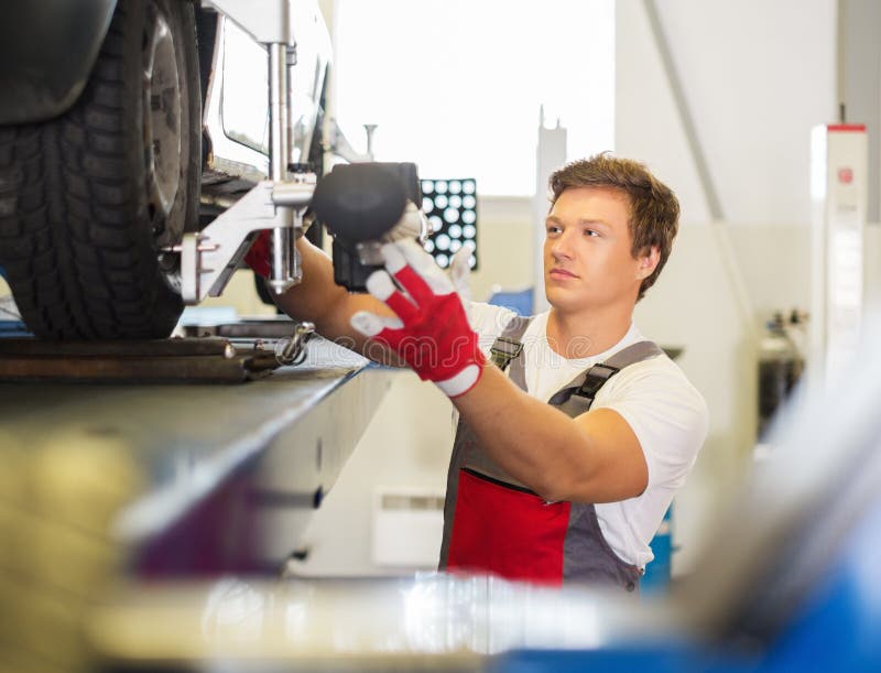 Serviceman in car workshop stock photography