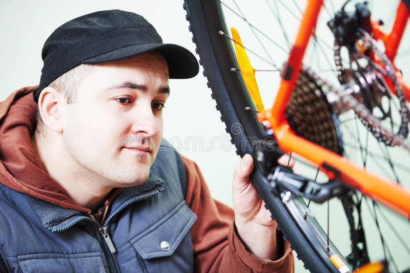serviceman installing assembling or adjusting bicycle gear on wh stock images serviceman installing assembling or adjusting bicycle gear on wh stock images