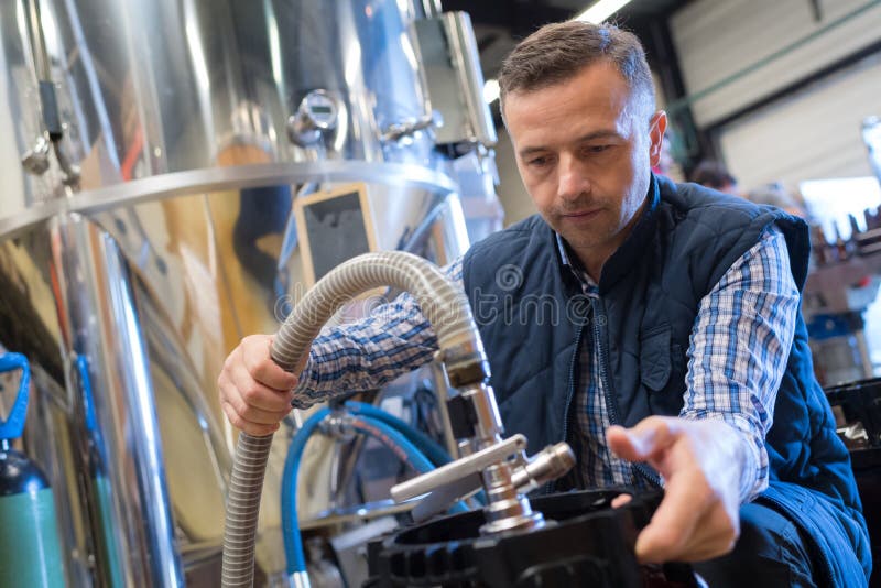 Serviceman operating industrial water purification royalty free stock photography Serviceman operating industrial water purification royalty free stock photography