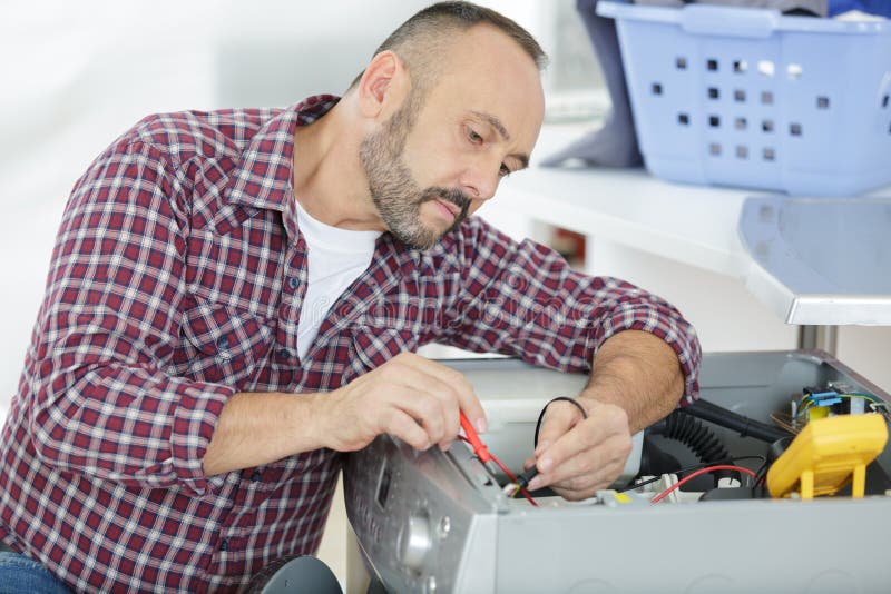 Serviceman Testing Washing Machine with Multimeter Stock Image Image