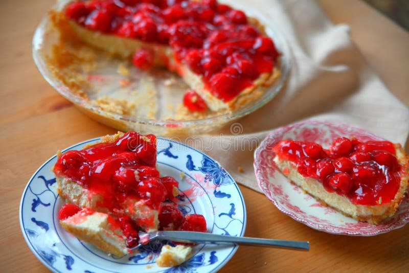 A cherry cream cheese pie served on decorative dishes. A cherry cream cheese pie served on decorative dishes