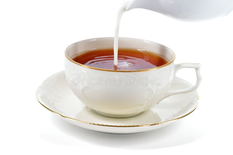 Serving cup of tea with milk.