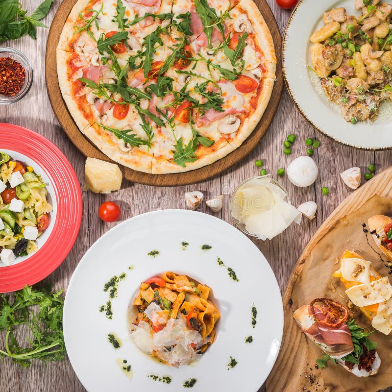 Serving table for lunch from pizza, pasta, bruschetta