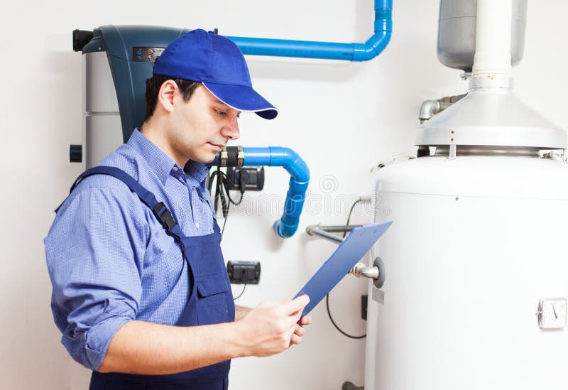 Technician servicing an hot-water heater. Technician servicing an hot-water heater