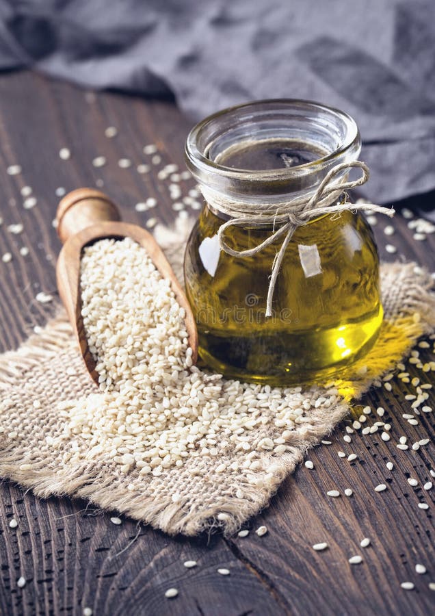 Sesame oil and seeds stock photo. Image of food, wood 91377058