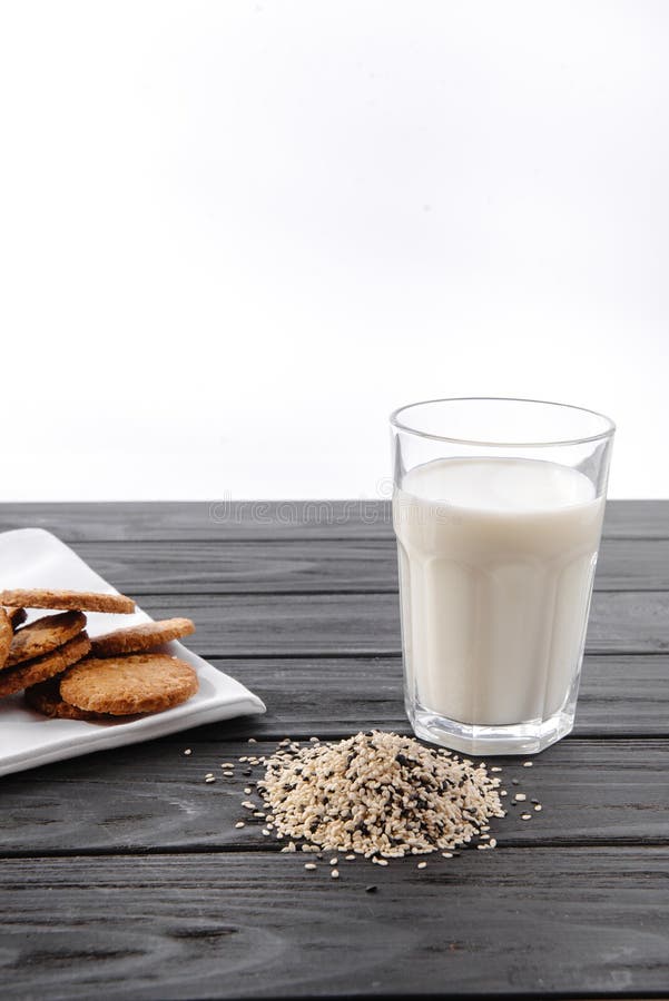 Sesame Seed Milk in a Glass. White Sesame Seeds on the Table. Raw Diet