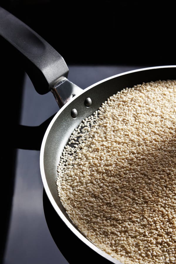 Sesame seeds in black frying pan