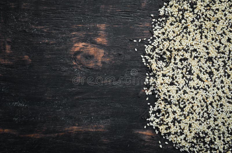 Sesame. Set of Black and White Sesame Seeds. on a Black Background. Top