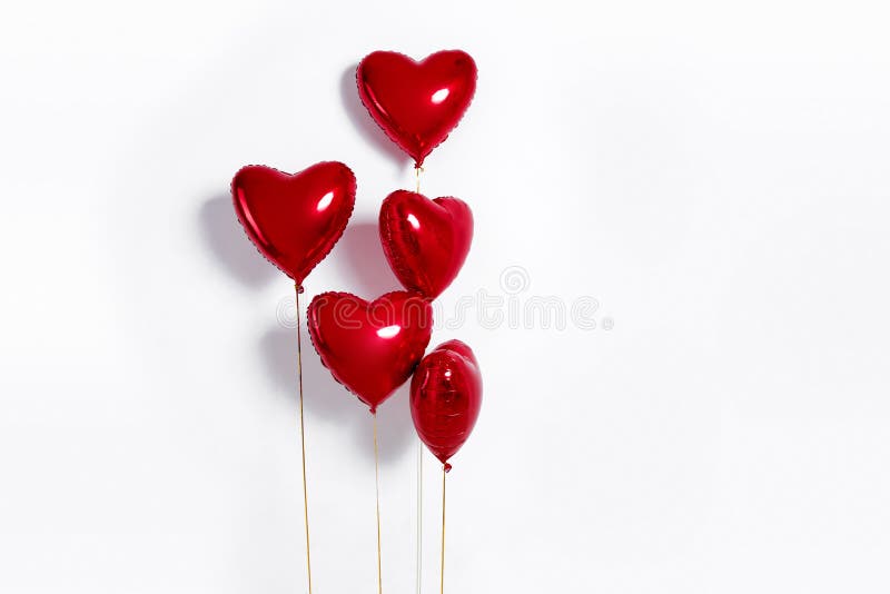 Set of Air Balloons. Bunch of red color heart shaped foil balloons isolated on white background. Love.