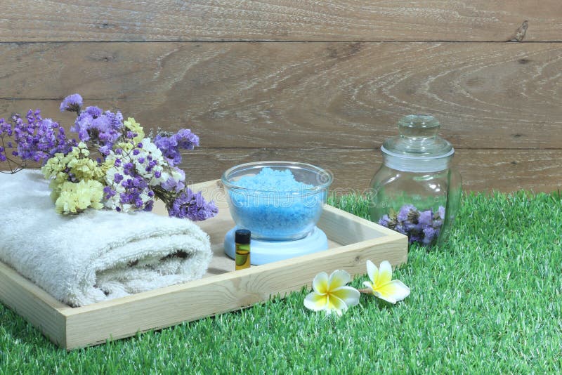 Set aromatherapy spa and candle with flowers on artificial grass. Set aromatherapy spa and candle with flowers on artificial grass and wooden background royalty free stock image Set aromatherapy spa and candle with flowers on artificial grass. Set aromatherapy spa and candle with flowers on artificial grass and wooden background royalty free stock image