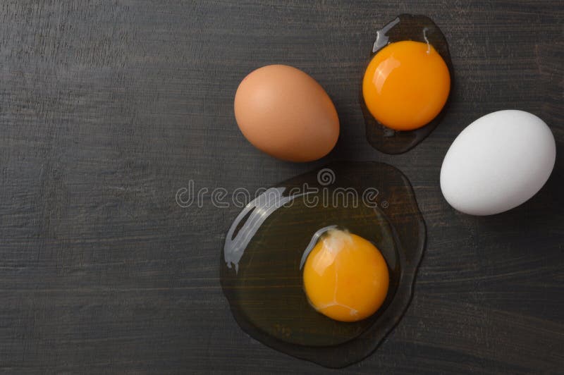 Set of Brown and White Eggs and Egg Yolks with Copy Space Stock Photo