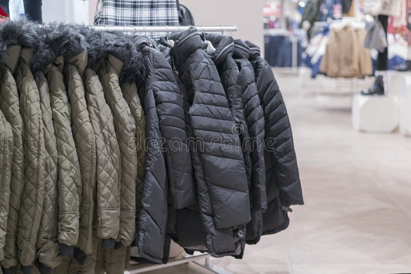 Set of Clothes, Coat on the Rack Clothing Shop Interior on Background.  Winter Jackets in a Store Stock Photo - Image of coat, casual: 140662814