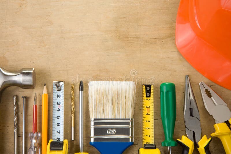 Set of construction tools on wood background