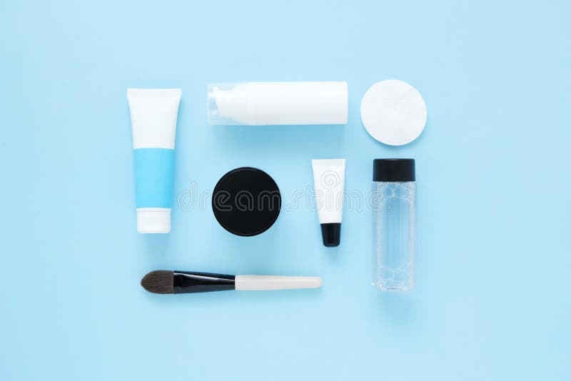 Set of cosmetic products on blue color background, flat lay with space for text. White tubes, branding mock up, top view. stock images Set of cosmetic products on blue color background, flat lay with space for text. White tubes, branding mock up, top view. stock images