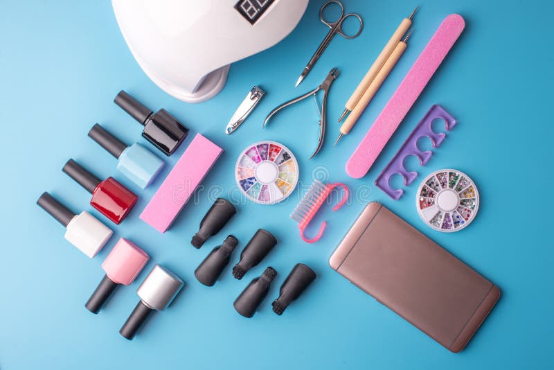 A Set of Cosmetic Tools for Manicure and Pedicure on a Blue Background ...