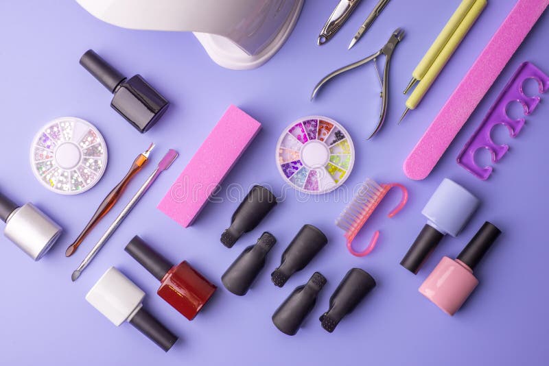 Set of Cosmetic Tools for Manicure and Pedicure on a Purple Background ...