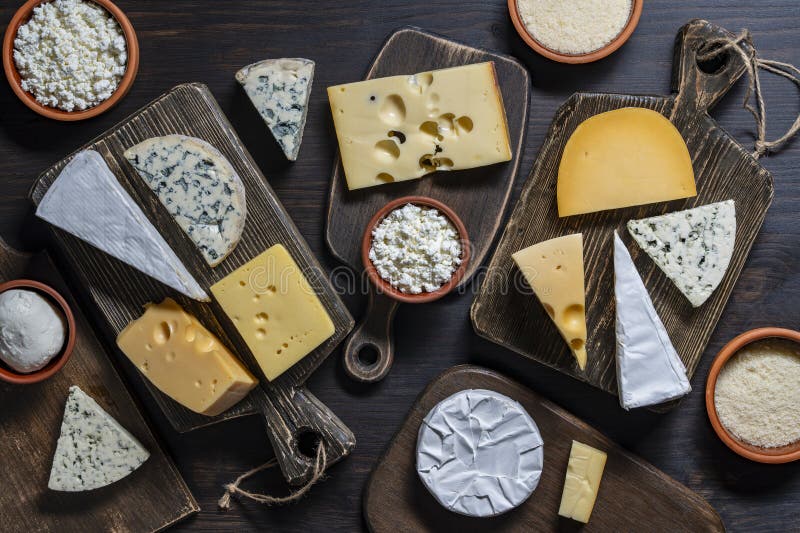 Set di formaggi diversi su tavolette di taglio in legno con vista superiore. Vari tipi di formaggio immagini stock libere da diritti