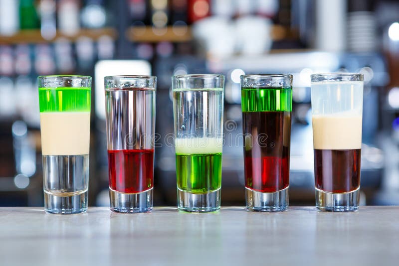 Set of Different Alcoholic Shots Cocktails Served on Bar Counter Stock