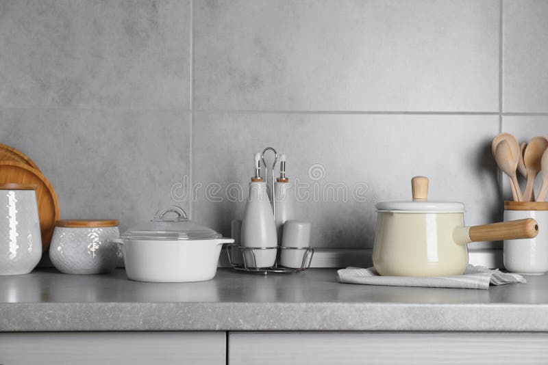 Set of Different Cooking Utensils on Grey Countertop in Kitchen Stock
