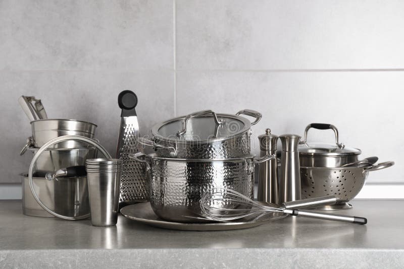 Set of Different Cooking Utensils on Grey Countertop in Kitchen Stock
