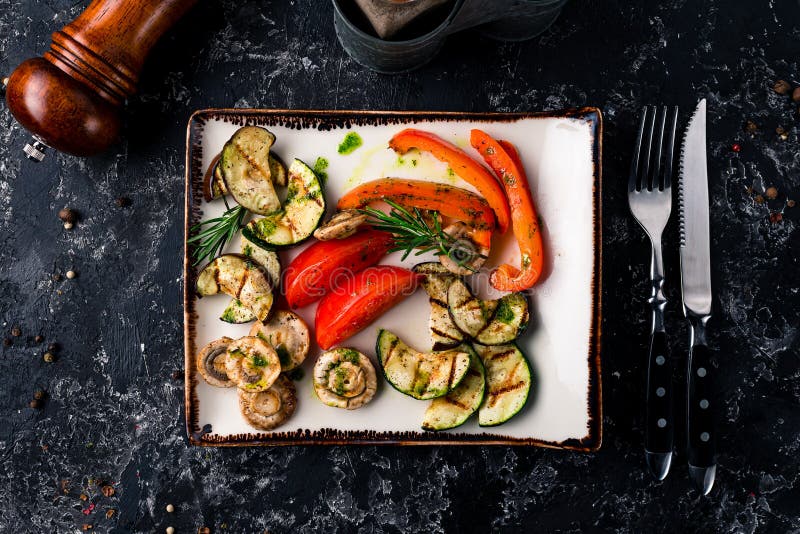 Set different grilled vegetables. Vegan barbeque picnic set, grilled hot vegetables on plate