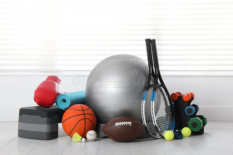 Set of Different Sports Equipment on White Floor Indoors Stock Image