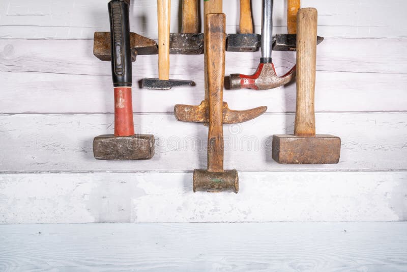 Set of Different Types of Old Hammers in Line at the Top of a Space on a Wooden Background. Top