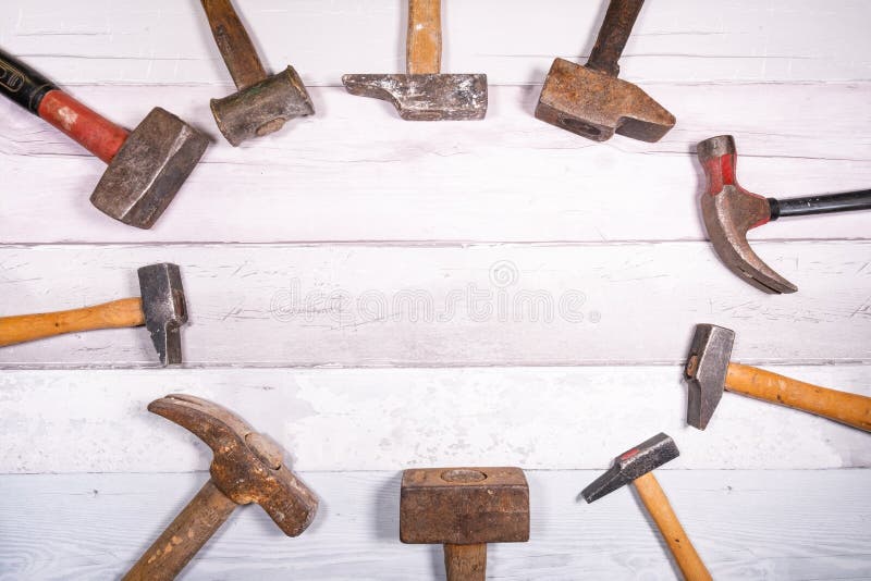 Set of Different Types of Old Hammers Put in Circles on a Wooden Background. Top View with Space