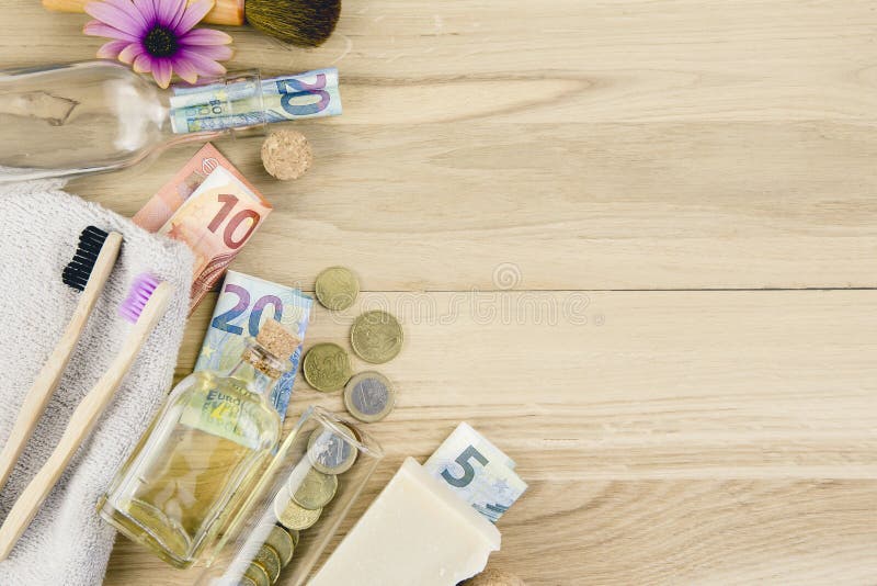 Set of different zero waste beauty products on wooden background with euro money bank notes around them. royalty free stock image Set of different zero waste beauty products on wooden background with euro money bank notes around them. royalty free stock image