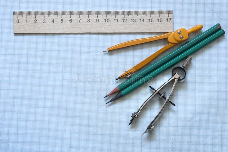 Set of drawing instrument and rulers on graph paper royalty free stock photo