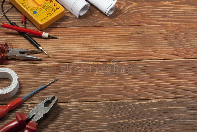 Set of electrical tool on wooden background. Accessories for engineering work, energy concept. royalty free stock photos Set of electrical tool on wooden background. Accessories for engineering work, energy concept. royalty free stock photos