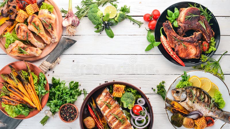 A set of food. Steak, Fish, Vegetables and Spices. On a wooden background.