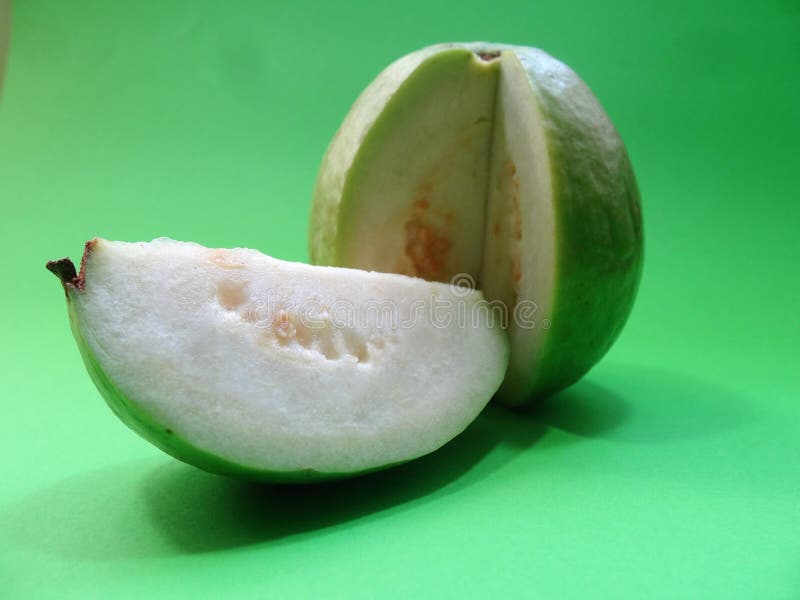 Guayaba on a green background sliced cut 2