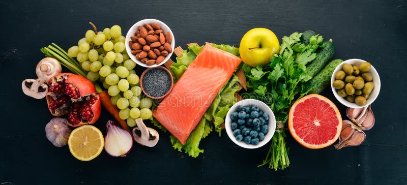 A Set of Healthy Food. Fish, Nuts, Protein, Berries, Vegetables and Fruits.  on a Black Wooden Background Stock Image - Image of fruits, animal:  151225157