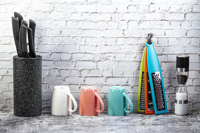 A Set of Kitchen Utensils on a Gray Marble Table Near a Light Wall