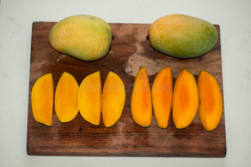 Set of mango fruits and mango slices stock photo