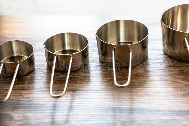 Set of Measuring Cups Made from Stainless with a Handle on Wooden