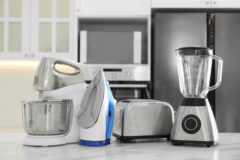 Set of Modern Home Appliances on Marble Table in Kitchen Stock Photo
