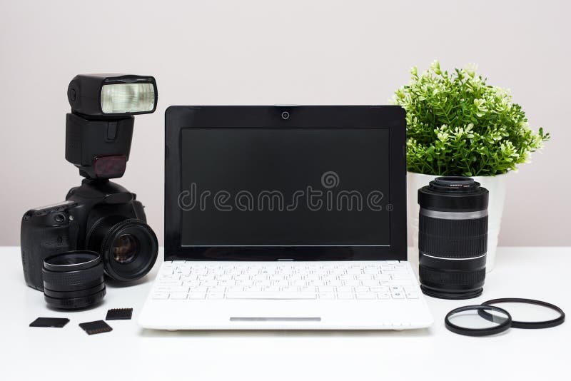 Set of modern photography equipment and laptop on the table stock images