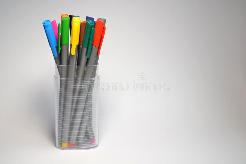 A Set of Multi-colored Pens with Caps in Transparent Plastic Case, Stand on  a Rainbow Background, Vertically Oriented Stock Photo - Image of ballpoint,  colorful: 165922124
